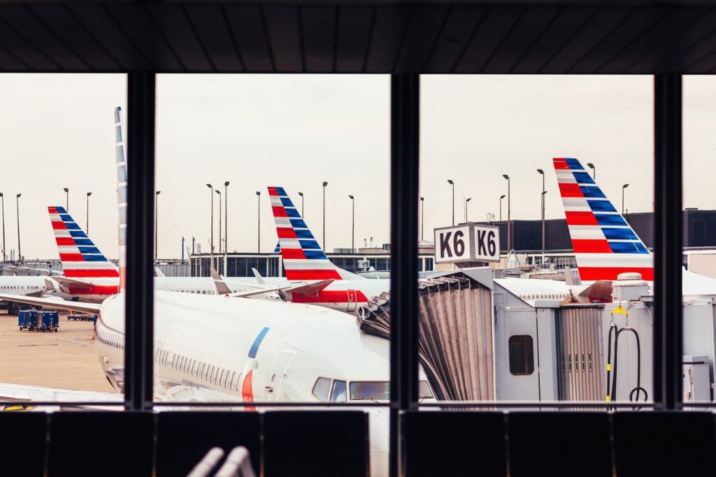 American Airlines airplanes parked at airport gates, viewed from inside the terminal.